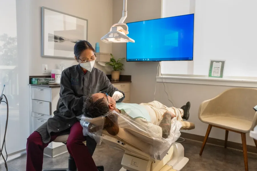 Dentist treating a patient in the dental chair