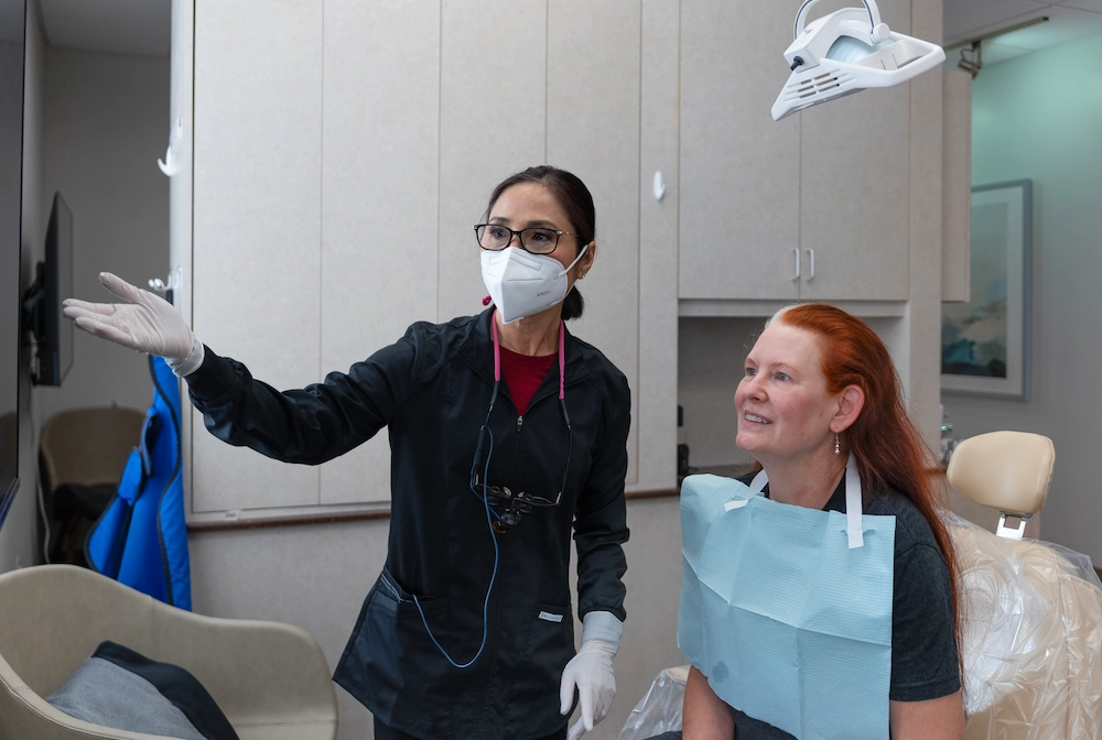 Man and woman smiling after dental crown restoration