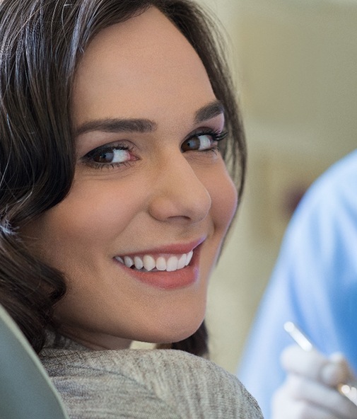 Smiling woman visiting her emergency dentist in Los Gatos, CA