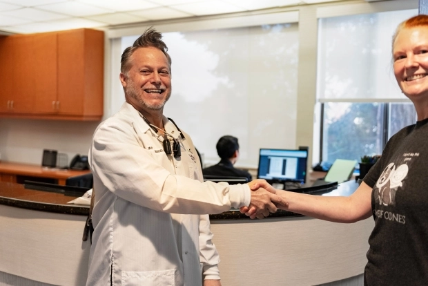 Dental patient shaking hands with dentist