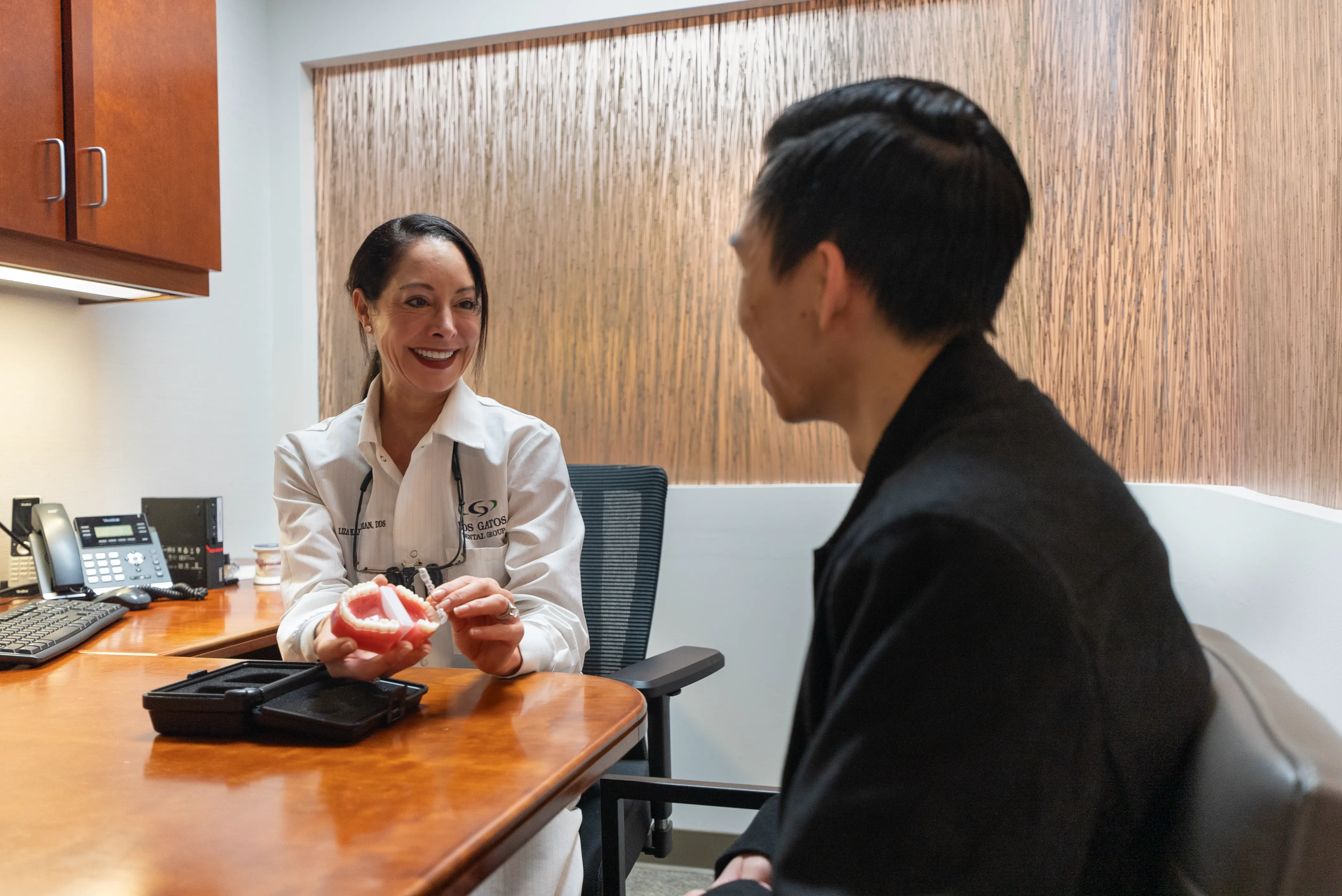 Two teens smiling during orthodontics treatment