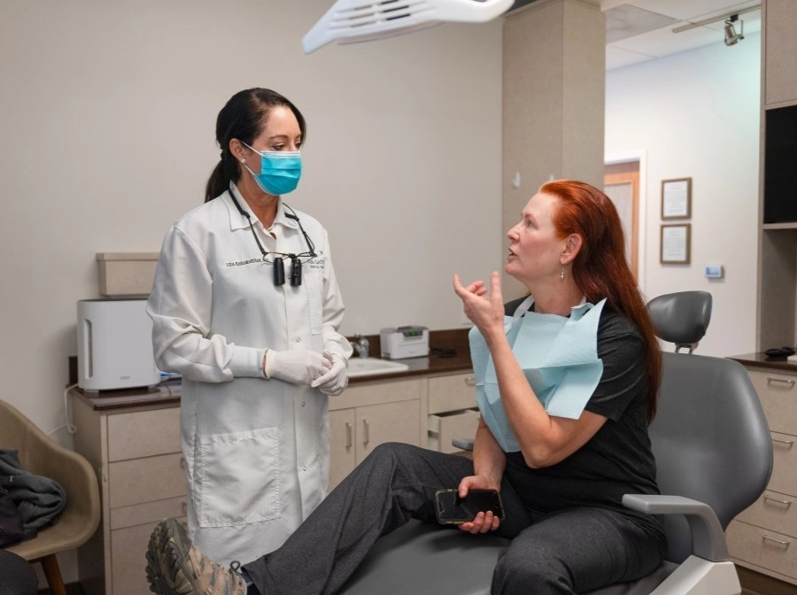 A doctor and a woman discussing various treatment options for gum disease