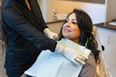 woman sitting in a dental chair, prepared for a dental intervention