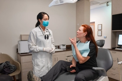 Doctor talking to the patient in need of emergency dentistry