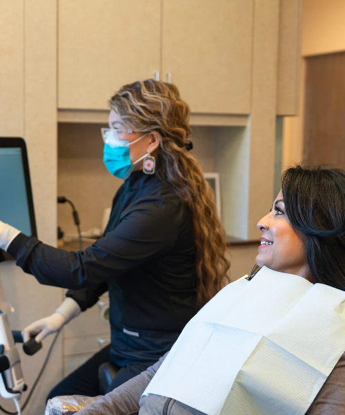 Dental team member setting up I V conscious dental sedation drip